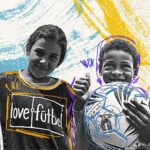 lovefutbol logo on young girl's shirt with boy holding soccer ball