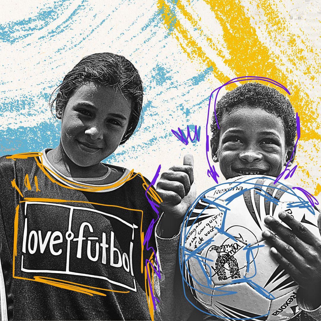 lovefutbol logo on young girl's shirt with boy holding soccer ball